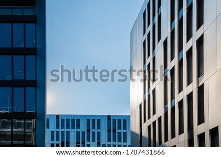 Different types of modern office building facades in front of blue sky