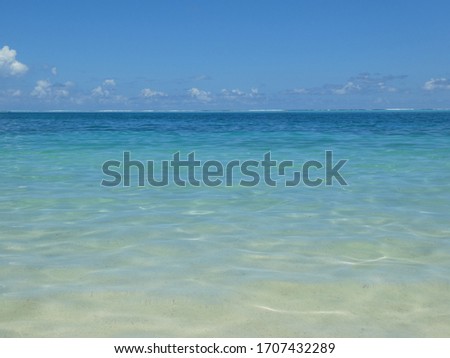 Translucent turquoise, rippling ocean, vivid blue sky. A tranquil paradise.