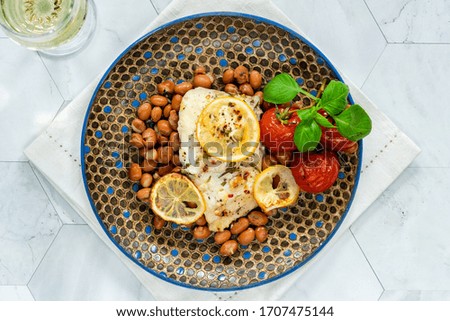 Halibut baked in white wine with borlotti beans and tomatoes - overhead view