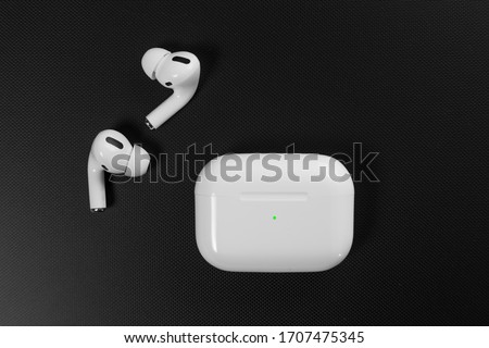 Air Pods Pro. with Wireless Charging Case. New Airpods pro on black background. Airpods Pro. Copy space. white wireless headphones on black surround background Royalty-Free Stock Photo #1707475345