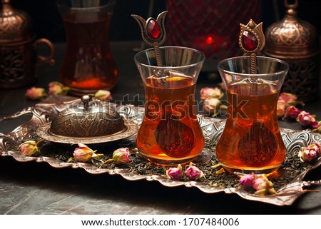 Turkish tea in traditional glass on tray, selective focus with shallow depth of field 