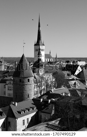 View of the old city in Tallinn. Fortress wall, spire of the St. Olaf’s Church