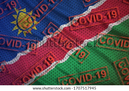 Namibia flag and many red Covid-19 stamps. Coronavirus or 2019-nCov virus concept