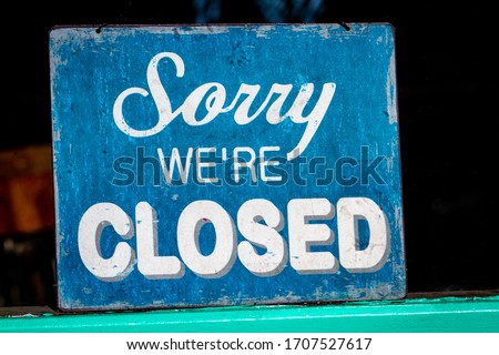 Sorry, we’re closed sign standing in a shop window Royalty-Free Stock Photo #1707527617