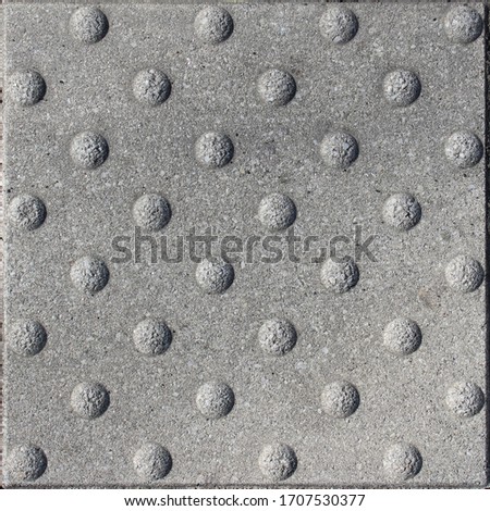 Sidewalk pedestrian crossing stones and parking spots signs textures