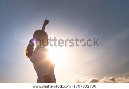 Strong female with fist up the sky. People strength, determination and power concept. 