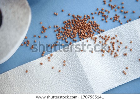 Buckwheat with toilet paper on a bare background. 2020 food. Coronavirus food.