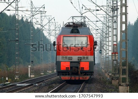 Front view of electric locomotive moving down a railway line Royalty-Free Stock Photo #1707547993