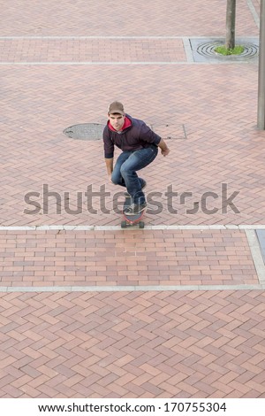 Skateboarder down the street.