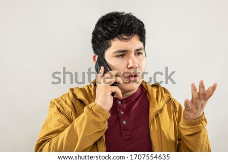 Expression session. Young man talking on the cellphone with different facial expressions