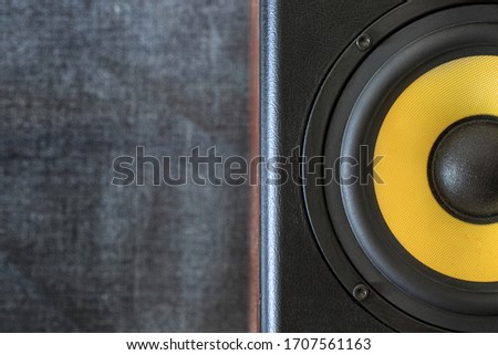Yellow woofer, black audio enclosure