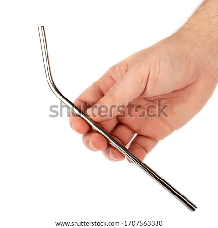 Stainless steel metal straw in hand on a white isolated background. Showing subject on a white background. Royalty-Free Stock Photo #1707563380