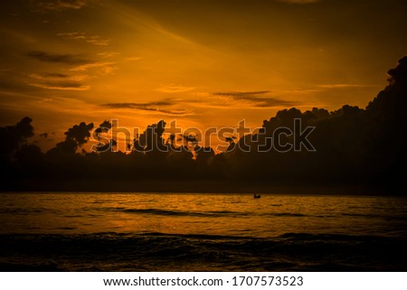 Its a Beautiful picture of a sunrise in a beach.