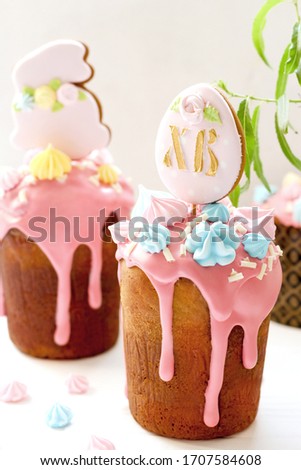 Easter cake for Easter with a pink decoration on top of a gingerbread rabbit and meringue