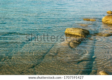 nature wallpaper poster scenic view picture of sea bay shallow water calm idyllic landscape with bottom and stones, empty copy space for your text here 