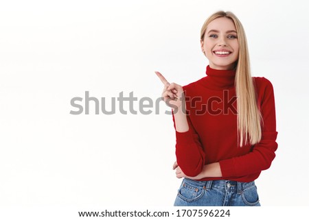 Work, career and lifestyle concept. Confident successful woman in red turtleneck pointing finger upper left corner, smiling pleased, give advice, recommend offer or promo product, white background
