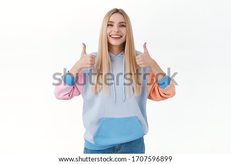 Satisfied cheerful, attractive blonde girl recommend shopping site or promo offer, show thumbs-up in like or approval, agree with you, like and accept, give advice, standing white background