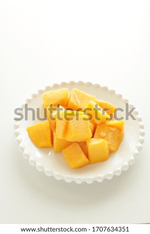 Frozen mango on white dish for stock food 
