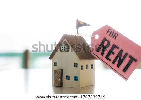 Miniature Home for rent mortgage of fee concept: DIY pink model Driftwood with tag paper "For Rent" indicate for needs of renting house for people who do not have homeowner,real estate investment idea