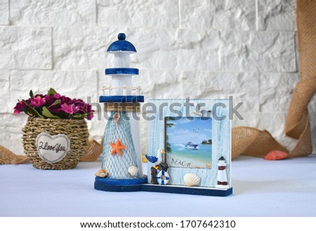 Still Life with Lighthouse photo frame and bunch of flowers
