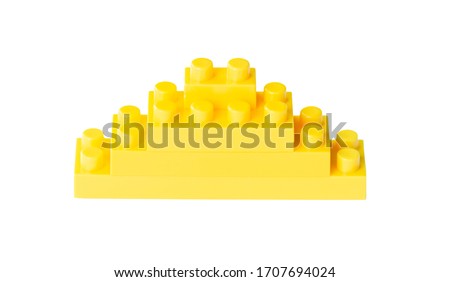 Pyramid of Yellow toy bricks isolated on white.