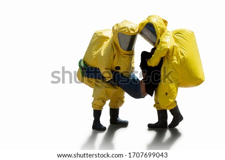 medical officers and hazmat (hazardous material) suits carry victim isolated to white background with clipping path