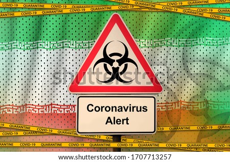Iran flag and Covid-19 biohazard symbol with quarantine orange tape. Coronavirus or 2019-nCov virus concept