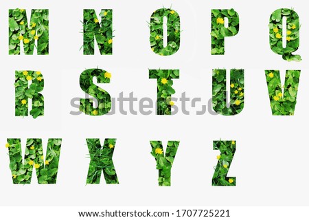 Green vegetation forms letters with the effect of volume Royalty-Free Stock Photo #1707725221