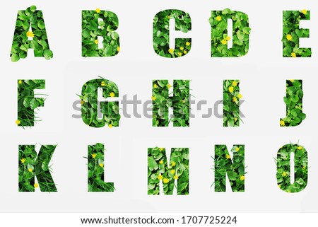 Green vegetation forms letters with the effect of volume Royalty-Free Stock Photo #1707725224