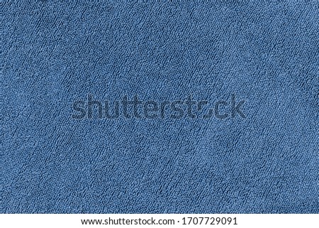 Blue terry towel close up. Abstract fabric textile texture background.