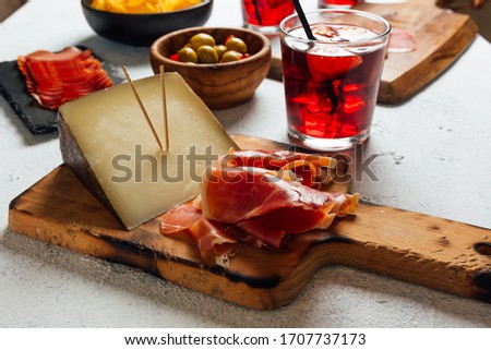 Pictures of typical Spanish food snacks (tapas). Composed of Sangria, iberian ham, manchego cheese and olives
