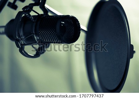 A black microphone is used for recording audio.