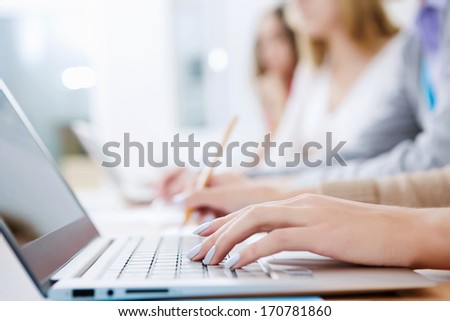 Close up image of young people using laptop at classroom Royalty-Free Stock Photo #170781860