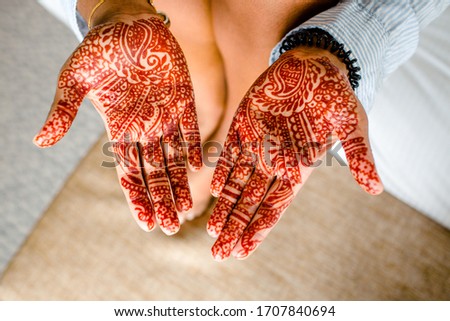 St Andrews, United Kingdom - August, 2018. Indian woman showing her henna tattoo on her wedding day