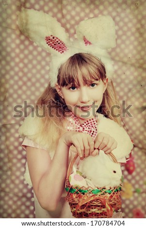 vintage easter bunny girl with funny ears holding eggs and rabbit in the basket