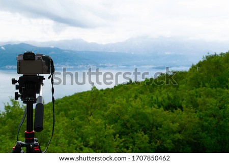 Photo camera on a tripod captures the Bay of Kotor Montenegro.