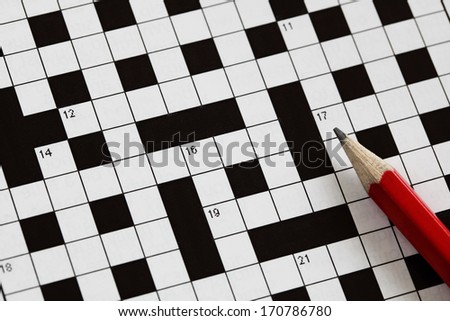 Solving a crossword puzzle with red pencil Royalty-Free Stock Photo #170786780