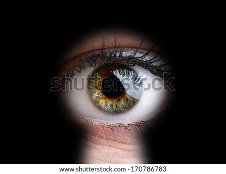 Female eye peeking through a keyhole concept for curiosity, stalker, surveillance and security Royalty-Free Stock Photo #170786783