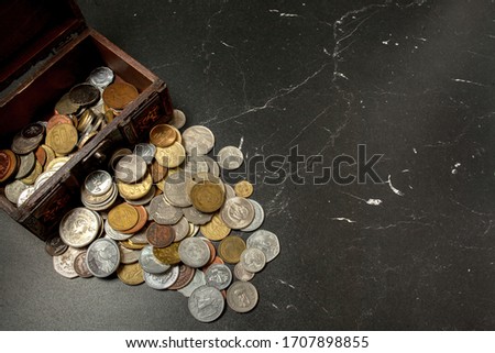 old coins collection in an ancient wooden chest box