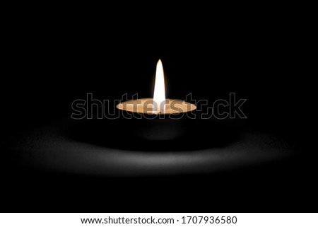 A candle is lit in memory of those who died from the coronavirus.Covid19 pandemic Royalty-Free Stock Photo #1707936580