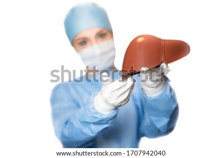 Liver and a female doctor surgeon, focus on the liver Royalty-Free Stock Photo #1707942040