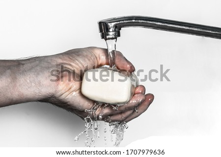 Washing of hand of a sick person with soap under running water. on a white background