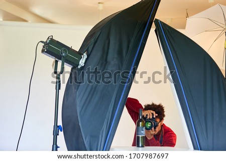 Professional photographer takes product. Photo of a bottle in the photo studio