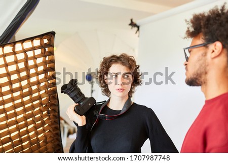 Photographer and photo assistant discuss and plan a photo shoot