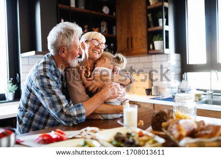 Happy grandchildrens girls having breakfast with her grandparents Royalty-Free Stock Photo #1708013611