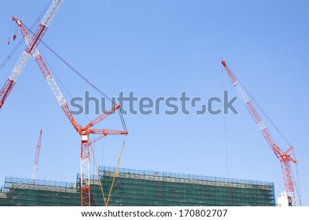 Construction site with crane over a building  