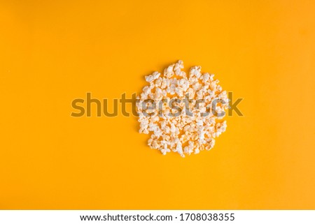 Popcorn in the shape of record button on yellow background. Flat lay banner, top view. Cinema, movies and entertainment concept.