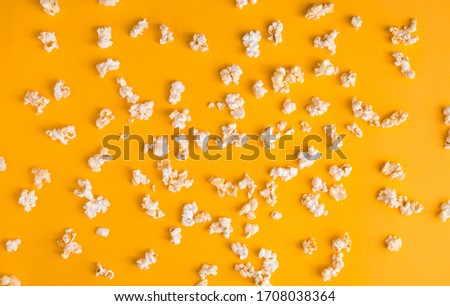 Tasty popcorn pattern on yellow background. Flat lay banner, top view. Cinema, movies and entertainment concept.