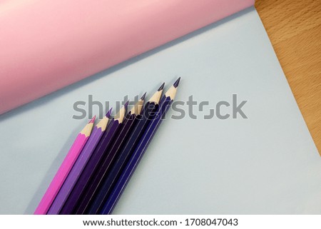 
set of colored pencils on a background laid out by a rainbow