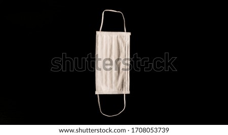 white medical five-layer mask on a black background isolate